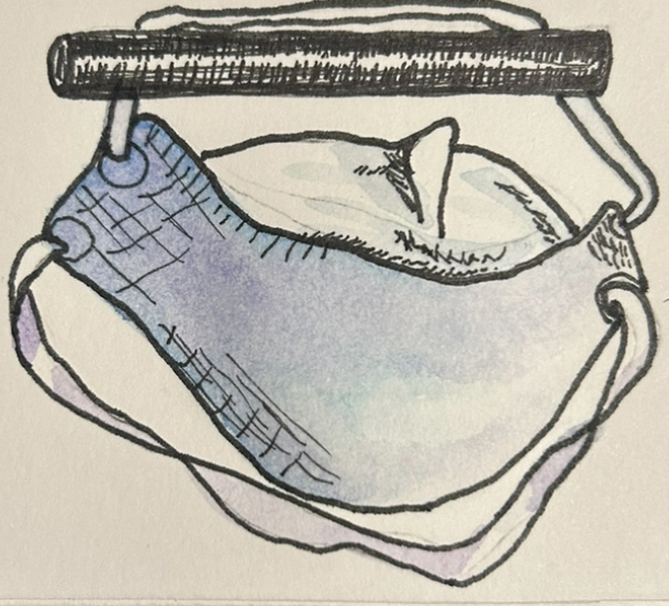 A drawing of a white mask hanging from a dresser pull